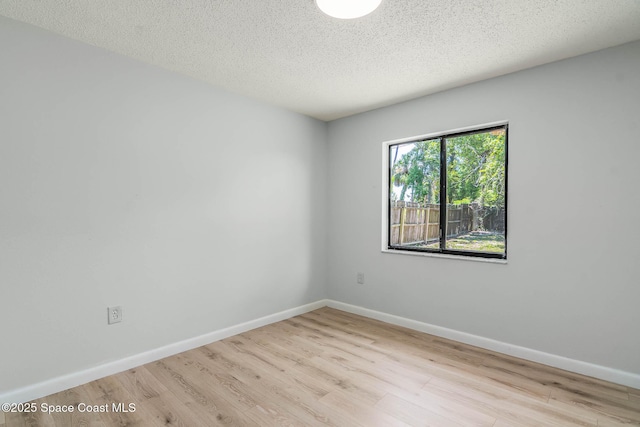 1384 Vancouver Ave SE, Palm Bay, FL 32909 - spare room with wood finished floors and a textured ceiling