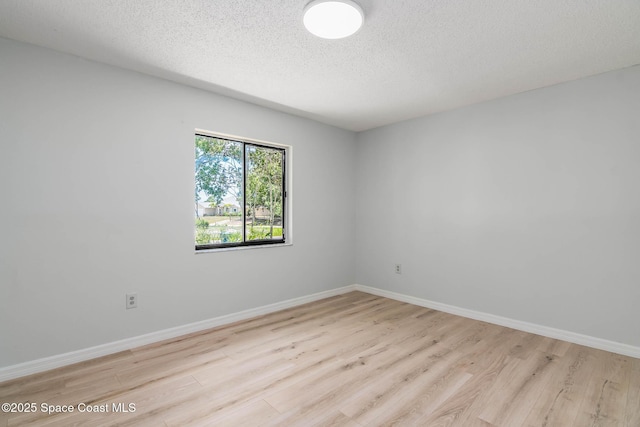 1384 Vancouver Ave SE, Palm Bay, FL 32909 - unfurnished room with wood finished floors and a textured ceiling