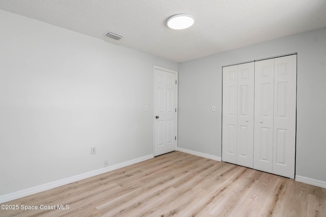 1384 Vancouver Ave SE, Palm Bay, FL 32909 - unfurnished bedroom featuring wood finished floors and a closet