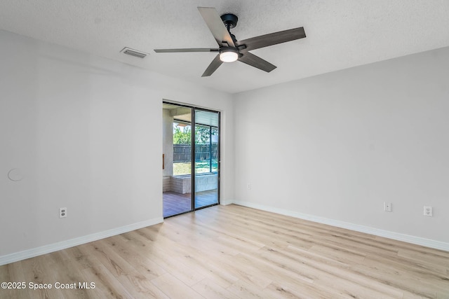 1384 Vancouver Ave SE, Palm Bay, FL 32909 - spare room with ceiling fan, wood finished floors, and a textured ceiling