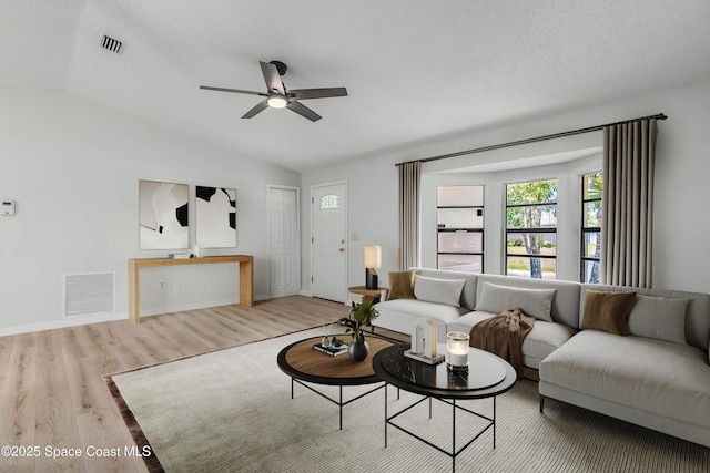 1384 Vancouver Ave SE, Palm Bay, FL 32909 - living room with vaulted ceiling, wood finished floors, and a ceiling fan