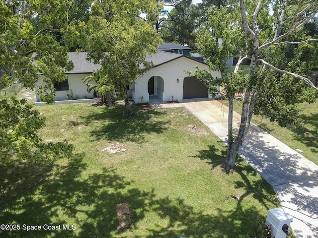 1384 Vancouver Ave SE, Palm Bay, FL 32909 - view of property hidden behind natural elements featuring stucco siding, concrete driveway, a garage, a front yard, and roof with shingles