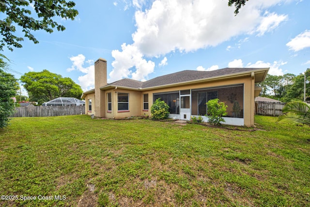 6980 Cairo Rd, Cocoa, FL 32927 - rear view of property with a sunroom, a chimney, a fenced backyard, and stucco siding