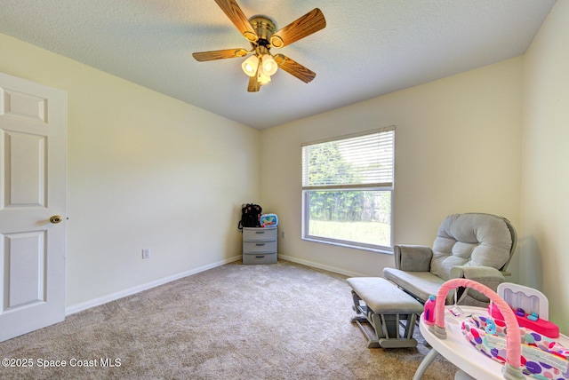 6980 Cairo Rd, Cocoa, FL 32927 - sitting room featuring carpet floors, ceiling fan, and a textured ceiling