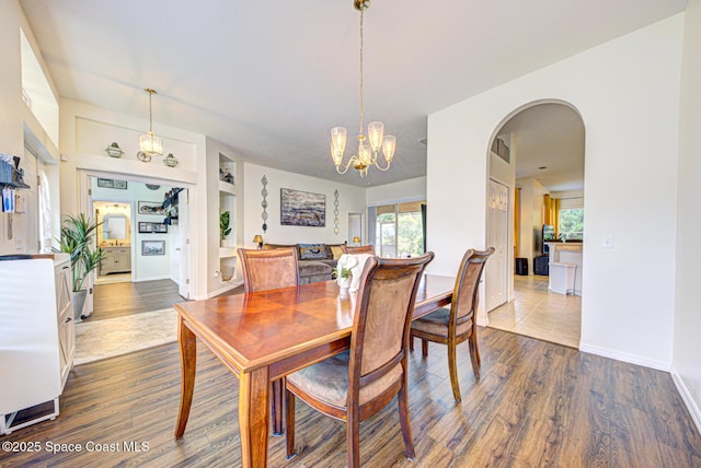 6980 Cairo Rd, Cocoa, FL 32927 - dining room with healthy amount of natural light, arched walkways, a chandelier, and built in features