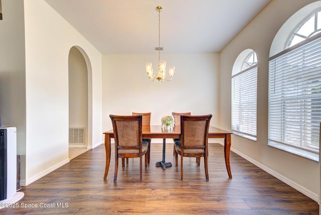 6980 Cairo Rd, Cocoa, FL 32927 - dining space featuring a chandelier, plenty of natural light, and dark wood-style flooring
