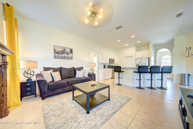 6980 Cairo Rd, Cocoa, FL 32927 - living room featuring arched walkways, light tile patterned floors, ceiling fan, and recessed lighting