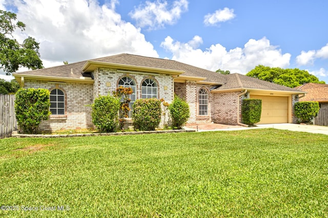 6980 Cairo Rd, Cocoa, FL 32927 - view of front facade with concrete driveway, brick siding, a garage, and roof with shingles