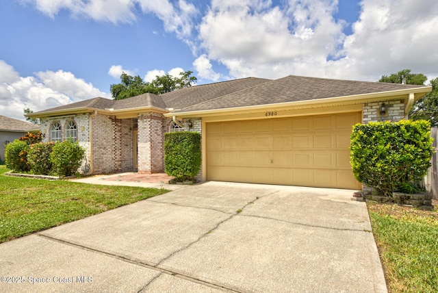 6980 Cairo Rd, Cocoa, FL 32927 - single story home featuring an attached garage, driveway, brick siding, roof with shingles, and a front yard