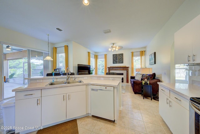 6980 Cairo Rd, Cocoa, FL 32927 - kitchen with white dishwasher, open floor plan, a fireplace, ceiling fan, and light countertops