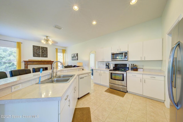 6980 Cairo Rd, Cocoa, FL 32927 - kitchen featuring appliances with stainless steel finishes, open floor plan, light tile patterned flooring, light countertops, and white cabinetry