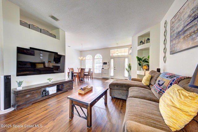 6980 Cairo Rd, Cocoa, FL 32927 - living room featuring a chandelier, wood finished floors, and a textured ceiling