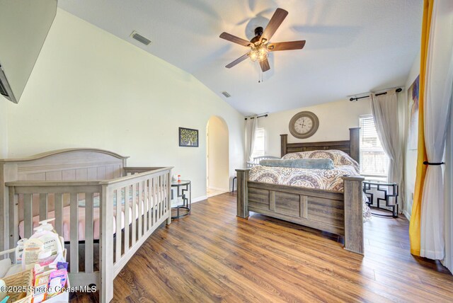 6980 Cairo Rd, Cocoa, FL 32927 - bedroom with arched walkways, vaulted ceiling, and wood finished floors