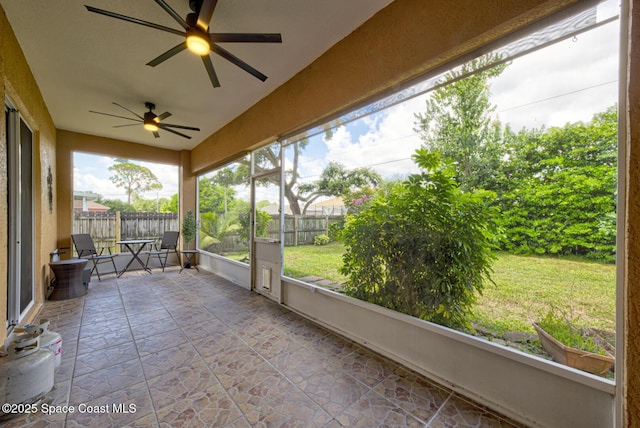 6980 Cairo Rd, Cocoa, FL 32927 - unfurnished sunroom with vaulted ceiling, a ceiling fan, and healthy amount of natural light
