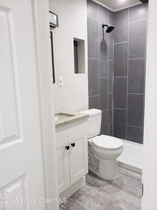 5600 N Banana River Blvd Unit 38, Cocoa Beach, FL 32931 - bathroom featuring vanity, a shower stall, and tile walls