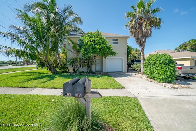 105 Ocean View Ln, Melbourne, FL 32903 - obstructed view of property with stucco siding, a garage, concrete driveway, and a front yard