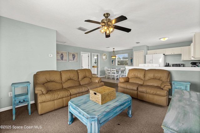105 Ocean View Ln, Melbourne, FL 32903 - carpeted living room with a ceiling fan and baseboards