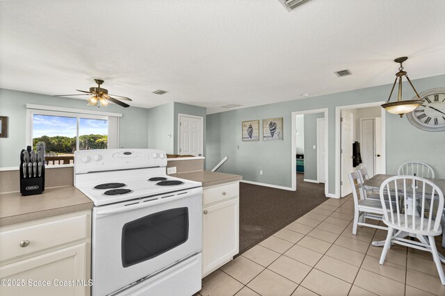 105 Ocean View Ln, Melbourne, FL 32903 - kitchen featuring electric range, white cabinetry, a ceiling fan, light countertops, and light tile patterned floors