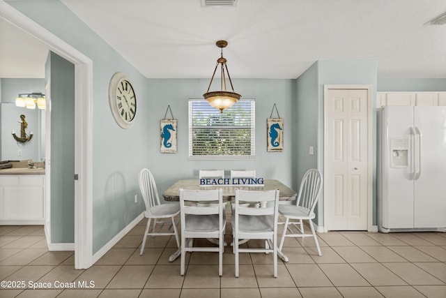 105 Ocean View Ln, Melbourne, FL 32903 - dining space featuring light tile patterned flooring and baseboards