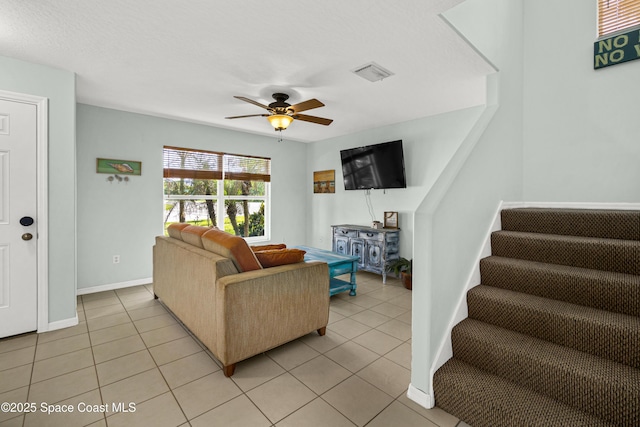 105 Ocean View Ln, Melbourne, FL 32903 - living area featuring light tile patterned flooring, ceiling fan, and stairway