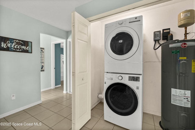 105 Ocean View Ln, Melbourne, FL 32903 - laundry room featuring electric water heater, stacked washing machine and dryer, and light tile patterned flooring