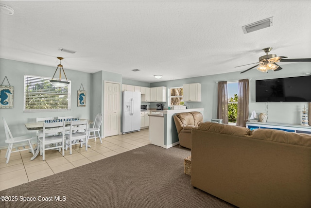 105 Ocean View Ln, Melbourne, FL 32903 - living room with light tile patterned floors, a ceiling fan, and a textured ceiling