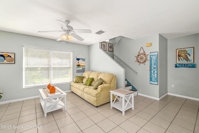 105 Ocean View Ln, Melbourne, FL 32903 - living area featuring light tile patterned floors, a ceiling fan, and stairway