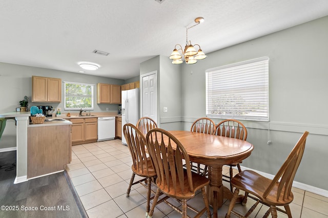 105 Ocean View Ln, Melbourne, FL 32903 - dining room featuring a chandelier, light tile patterned flooring, and a textured ceiling
