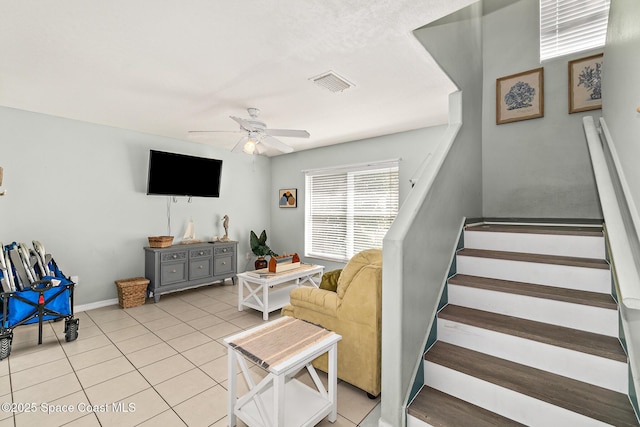105 Ocean View Ln, Melbourne, FL 32903 - living area featuring ceiling fan, light tile patterned floors, and stairs