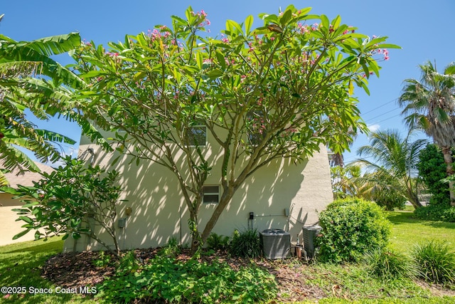 105 Ocean View Ln, Melbourne, FL 32903 - view of home's exterior featuring stucco siding and a central AC unit