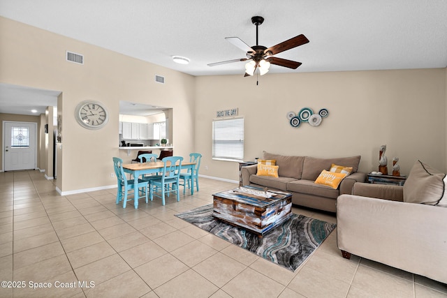 147 Ocean View Ln, Melbourne, FL 32903 - tiled living room with a ceiling fan and healthy amount of natural light