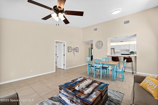 147 Ocean View Ln, Melbourne, FL 32903 - living area with light tile patterned flooring, a ceiling fan, and lofted ceiling