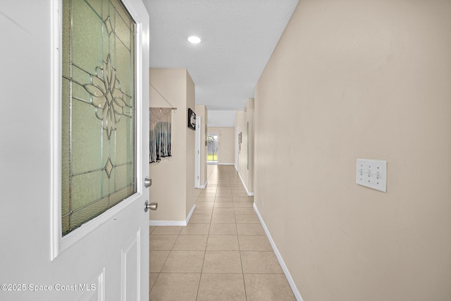 147 Ocean View Ln, Melbourne, FL 32903 - hallway with light tile patterned floors and a textured ceiling