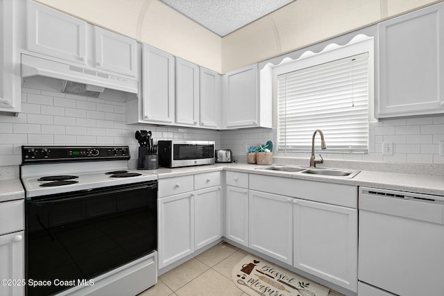 147 Ocean View Ln, Melbourne, FL 32903 - kitchen featuring electric range, dishwasher, stainless steel microwave, under cabinet range hood, and backsplash