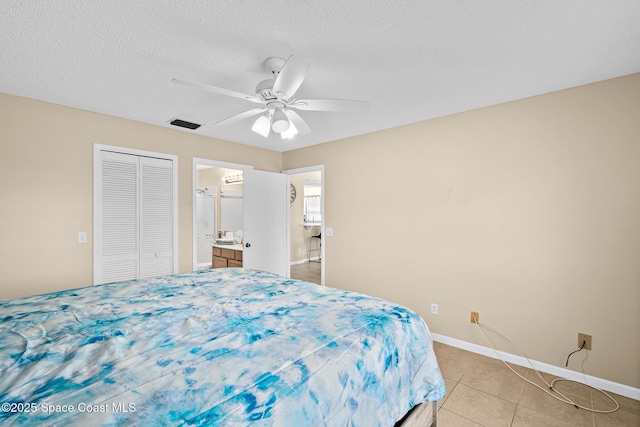 147 Ocean View Ln, Melbourne, FL 32903 - bedroom with a closet, light tile patterned floors, ceiling fan, and a textured ceiling
