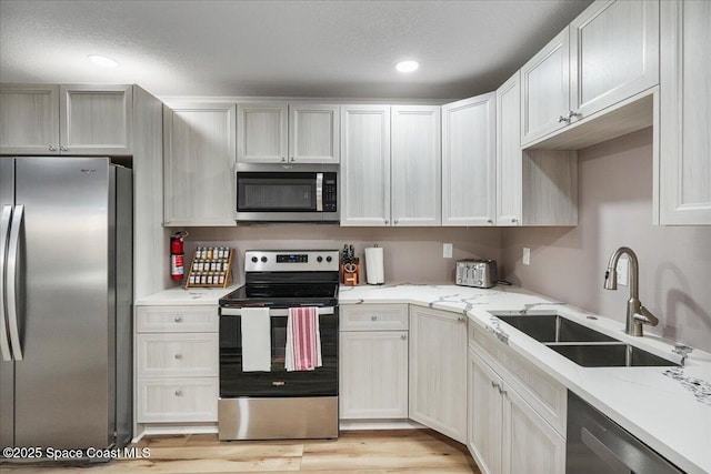 513 Ronnie Dr, Indian Harbour Beach, FL 32937 - kitchen with appliances with stainless steel finishes, light stone countertops, light wood-style floors, and recessed lighting