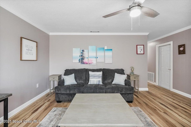 513 Ronnie Dr, Indian Harbour Beach, FL 32937 - living area featuring light wood-style flooring, crown molding, a ceiling fan, and a textured ceiling
