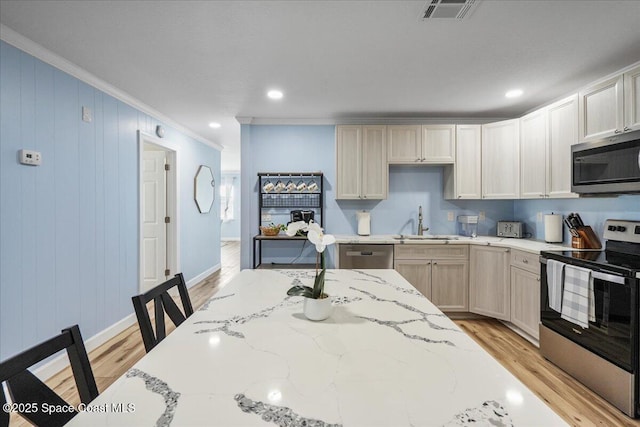 513 Ronnie Dr, Indian Harbour Beach, FL 32937 - kitchen featuring appliances with stainless steel finishes, crown molding, light wood finished floors, light stone counters, and recessed lighting