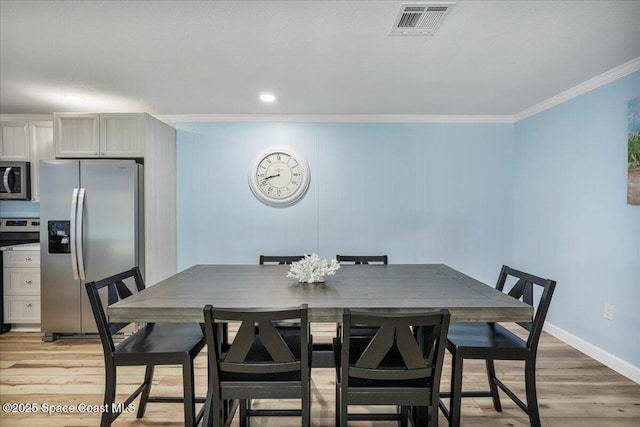 513 Ronnie Dr, Indian Harbour Beach, FL 32937 - dining space with ornamental molding and light wood-type flooring
