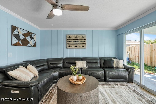 513 Ronnie Dr, Indian Harbour Beach, FL 32937 - living room with ornamental molding, a textured ceiling, ceiling fan, and a decorative wall