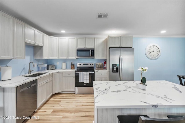 513 Ronnie Dr, Indian Harbour Beach, FL 32937 - kitchen with stainless steel appliances, light wood-type flooring, light stone counters, crown molding, and recessed lighting