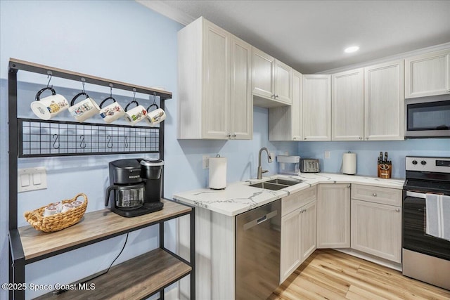513 Ronnie Dr, Indian Harbour Beach, FL 32937 - kitchen featuring appliances with stainless steel finishes, light wood-style flooring, light stone countertops, and recessed lighting