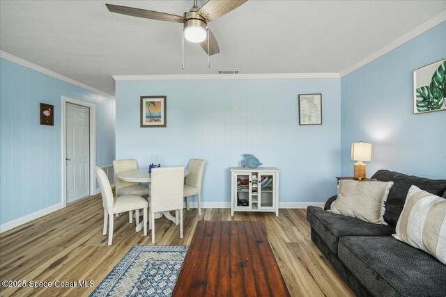 513 Ronnie Dr, Indian Harbour Beach, FL 32937 - dining room with ornamental molding, wood finished floors, and a ceiling fan