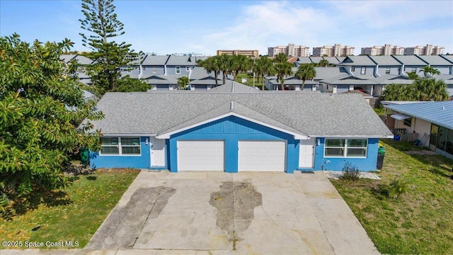 513 Ronnie Dr, Indian Harbour Beach, FL 32937 - view of front of property featuring an attached garage, roof with shingles, concrete driveway, and a front yard