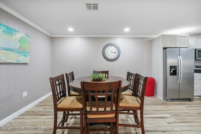 513 Ronnie Dr, Indian Harbour Beach, FL 32937 - dining space with light wood-style flooring, ornamental molding, and recessed lighting