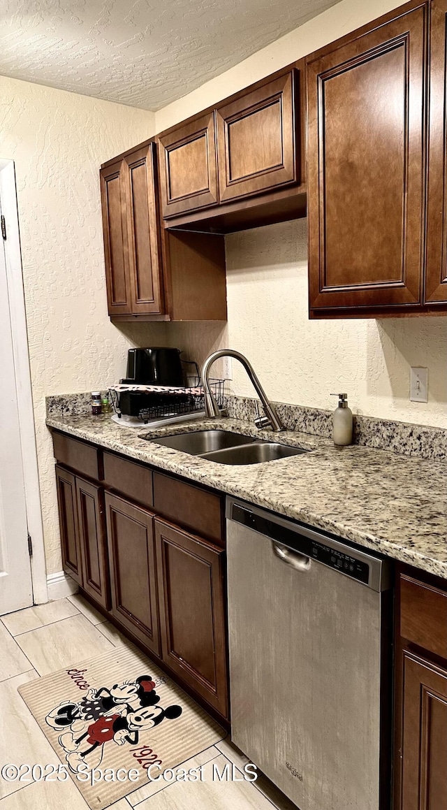 2190 Forest Knoll Dr NE Unit 90-202, Palm Bay, FL 32905 - kitchen with stainless steel dishwasher, a textured wall, a textured ceiling, dark brown cabinets, and light tile patterned floors