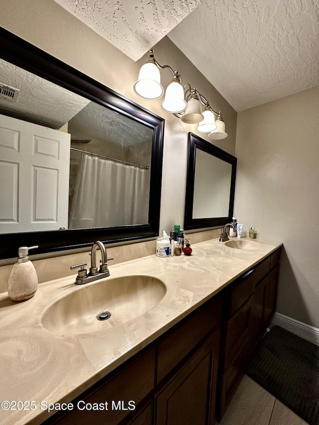2190 Forest Knoll Dr NE Unit 90-202, Palm Bay, FL 32905 - bathroom with a textured ceiling, double vanity, and curtained shower