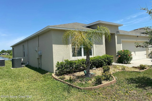 160 Old Mill Pond Rd, Edgewater, FL 32141 - view of side of home featuring stucco siding, a garage, concrete driveway, and a yard