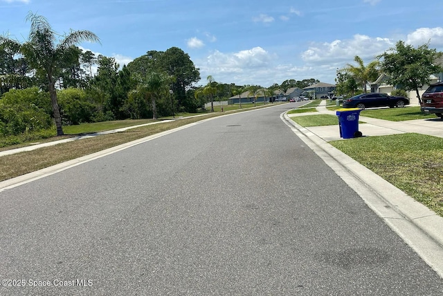 160 Old Mill Pond Rd, Edgewater, FL 32141 - view of asphalt road with curbs, a residential view, and sidewalks