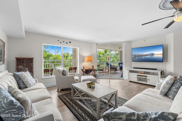 3360 S Atlantic Ave Unit 212, Cocoa Beach, FL 32931 - living room with a textured ceiling, ceiling fan, and wood finished floors